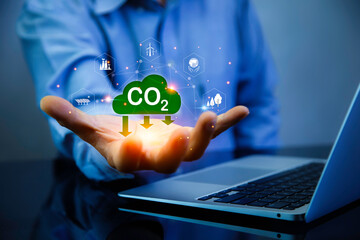 Green energy, Reduction of carbon emissions, carbon neutral concept. Carbon reduction sign on hand. Net zero greenhouse gas emissions target in 2050. Carbon dioxide emission in industry..