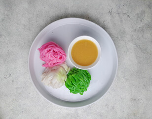 Kue putu mayang is an Indonesian Betawi string hopper dish made of starch or rice flour and coconut milk, then shaped like noodles. This noodle-like dish served with kinca in Betawi and Javanese 
