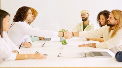 Men shaking hands closing a deal in a meeting room