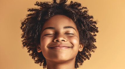 portrait of african descendant boy smiling with eyes closed, copy space
