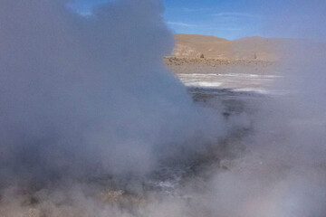 Fototapeta na wymiar Tatio Geysers in San Pedro de Atacama, Chile, South America. Dramatic volcanic hot springs with rising water and steam