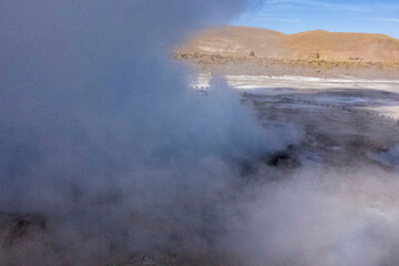 Fototapeta na wymiar Tatio Geysers in San Pedro de Atacama, Chile, South America. Dramatic volcanic hot springs with rising water and steam