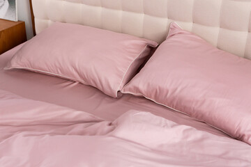 Fototapeta na wymiar pink cotton bed linen pillows
