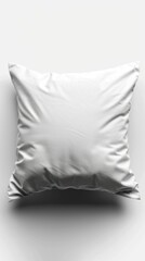 A white pillow resting on top of a white wall in a minimalist setting.