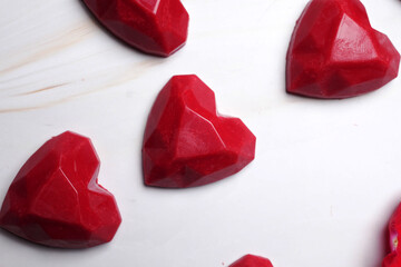 Valentine's Day concept. Heart shaped candies on a white marble background