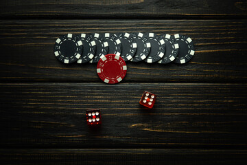 Very popular poker dice or Craps game on a dark vintage table and chips from a lucky win....