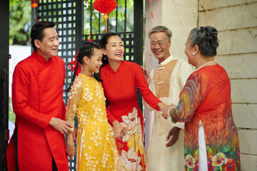 Happy family visiting grandparents for Lunar New Year celebration