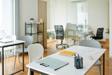 Desk with planners and documents in modern office of small startup