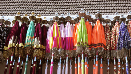 Multi colored decorated parasols kept for festival use