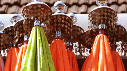 Multi colored decorated parasols kept for festival use