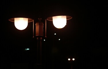 Street lamp with blurred dark nigh lights background