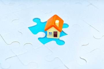 Jigsaw Puzzle and House Figurine