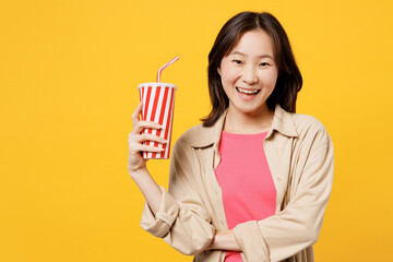 Young woman of Asian ethnicity wear pink t-shirt beige shirt pastel casual clothes looking camera...