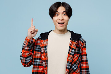 Young shocked surprised fun man of Asian ethnicity he wears red hoody casual clothes holding index...