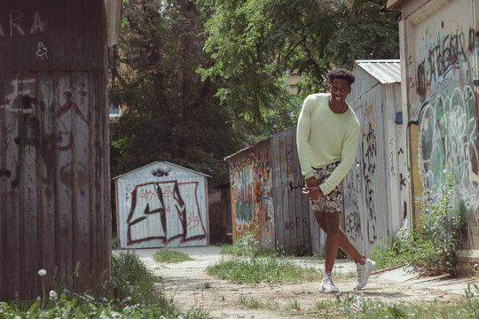 Urban Explorer: A Person Walking Between Graffiti-Covered Walls, Embodying the Spirit of the City