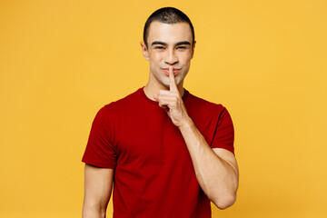 Young secret fun middle eastern man he wear red t-shirt casual clothes say hush be quiet with...