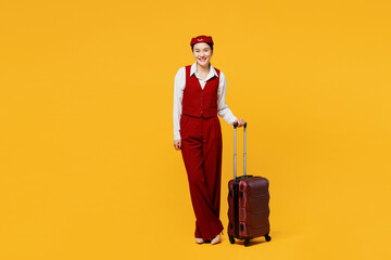 Full body happy young stewardess flight attendant woman of Asian ethnicity she wear red vest shirt...