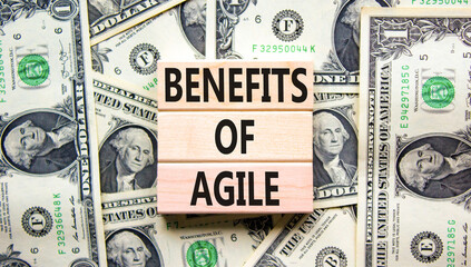 Benefits of agile symbol. Concept words Benefits of agile on beautiful wooden blocks. Dollar bills. Beautiful dollar bills background. Business benefits of agile concept. Copy space.