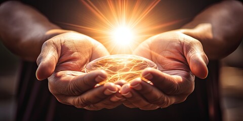 Hands clasped in prayer, illuminated by a radiant light, symbolizing divine presence and spiritual enlightenment - obrazy, fototapety, plakaty