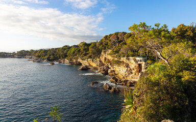 Plage de la Baie des Milliardaires. Beautiful beach and coastline at Cap d'Antibes at the French Riviera. Famous tourist spot at mediterranean sea in France.