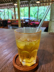 Orange juice in glass. Fresh fruits on wooden background