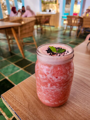 Fresh strawberry juice. Fresh summer juice with strawberry and ice cubes. Glass of strawberry soda drink in the restaurant