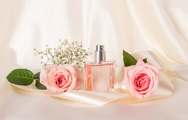 Beautiful still life with a bottle of women's perfume or cosmetic spray on a beige satin background...