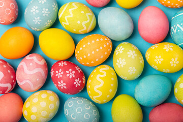 Easter eggs on a bright blue background. Easter celebration concept. Colorful easter handmade...