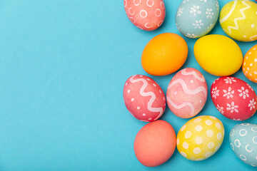 Easter eggs on a bright blue background. Easter celebration concept. Colorful easter handmade decorated Easter eggs. Place for text. Copy space.