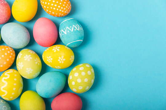 Easter eggs on a bright blue background. Easter celebration concept. Colorful easter handmade decorated Easter eggs. Place for text. Copy space.