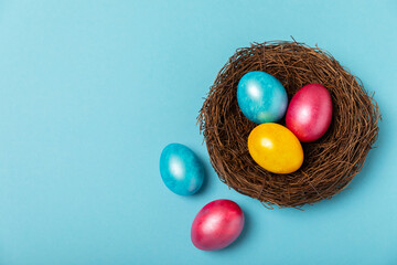 Easter eggs on a bright blue background. Easter celebration concept. Colorful easter handmade decorated Easter eggs. Place for text. Copy space.