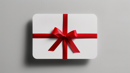 Blank white gift card with red ribbon bow, isolated