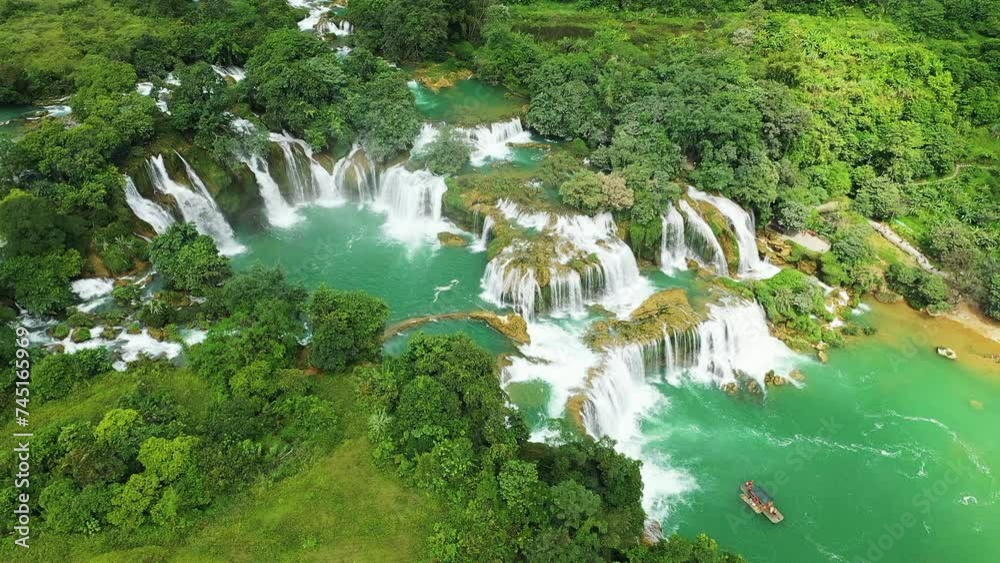 Wall mural The beautiful Ban Gioc waterfalls on the border with China with tourist boats , Asia, North Vietnam, Cao Bang, towards Lang Son, in summer on a sunny day.