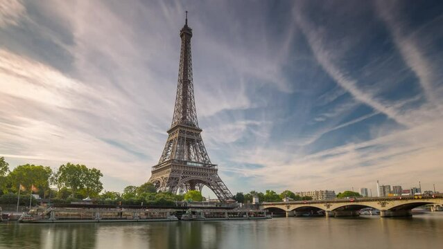 PARIS, FRANCE - FEBRUARY 20, 2024 : Timelapse motion hyperlapse view of the Eiffel Tower and Champ de Mars on embankment of the Seine River, famous touristic landmark.