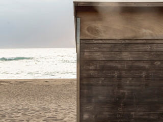 A solitary wooden cabin door stands on a tranquil beach,