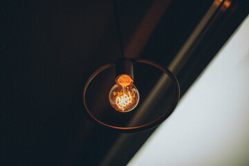 An incandescent lamp hangs in the apartment