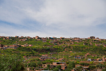 Fototapeta premium houses built on a hill, hillside settlements, urban development in latin america
