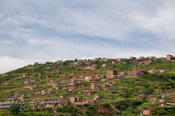 Fototapeta na wymiar houses built on a hill, hillside settlements, urban development in latin america