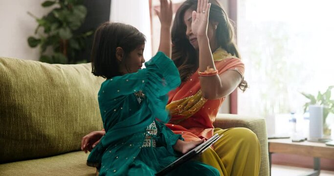 Mom, child and together with high five on tablet in home living room with e learning app, success or online course. Education, mother and daughter girl with digital touchscreen in Indian family house