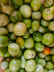 Close up of pile of raw natural green tomatoes