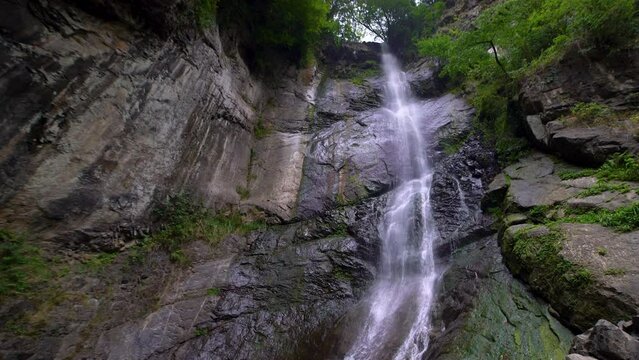 View of a waterfall in the mountains of a tropical forest.