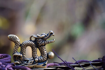 A figurine of a Chinese dragon with Chinese coins. Horoscope and feng shui.