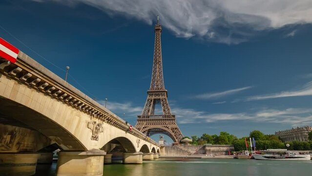 PARIS, FRANCE - FEBRUARY 20, 2024: Aerial drone timelapse motion hyperlapse view of the Eiffel Tower and Champ de Mars, famous touristic landmark.