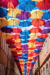 Fototapeta premium Colorful umbrellas hanging from the ceiling, perfect for adding a pop of color to any space