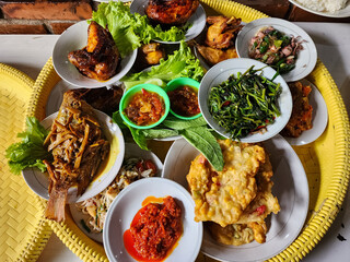 Traditional Sundanese meal of rice mixed with fermented soybean; accompanied with fried fish,...