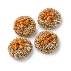 Traditional fresh baked Moroccan Ghoriba cookies topped with a walnut close up isolated on white background
