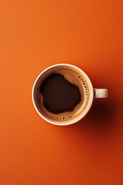 A simple image of a cup of coffee on an orange surface. Suitable for various coffee-related designs