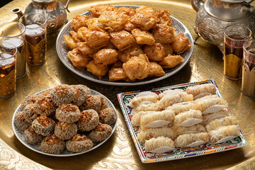 Traditional Moroccan table with plates patisserie cookies and tea close up