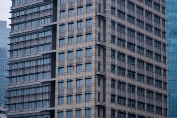 Exterior of modern skyscraper object. Architectural detail of a skyscraper, close-up on the windows. Real estate, residential apartments and offices. Office building architecture.