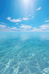Fototapeta na wymiar Sun shining on clear blue water, suitable for travel brochures